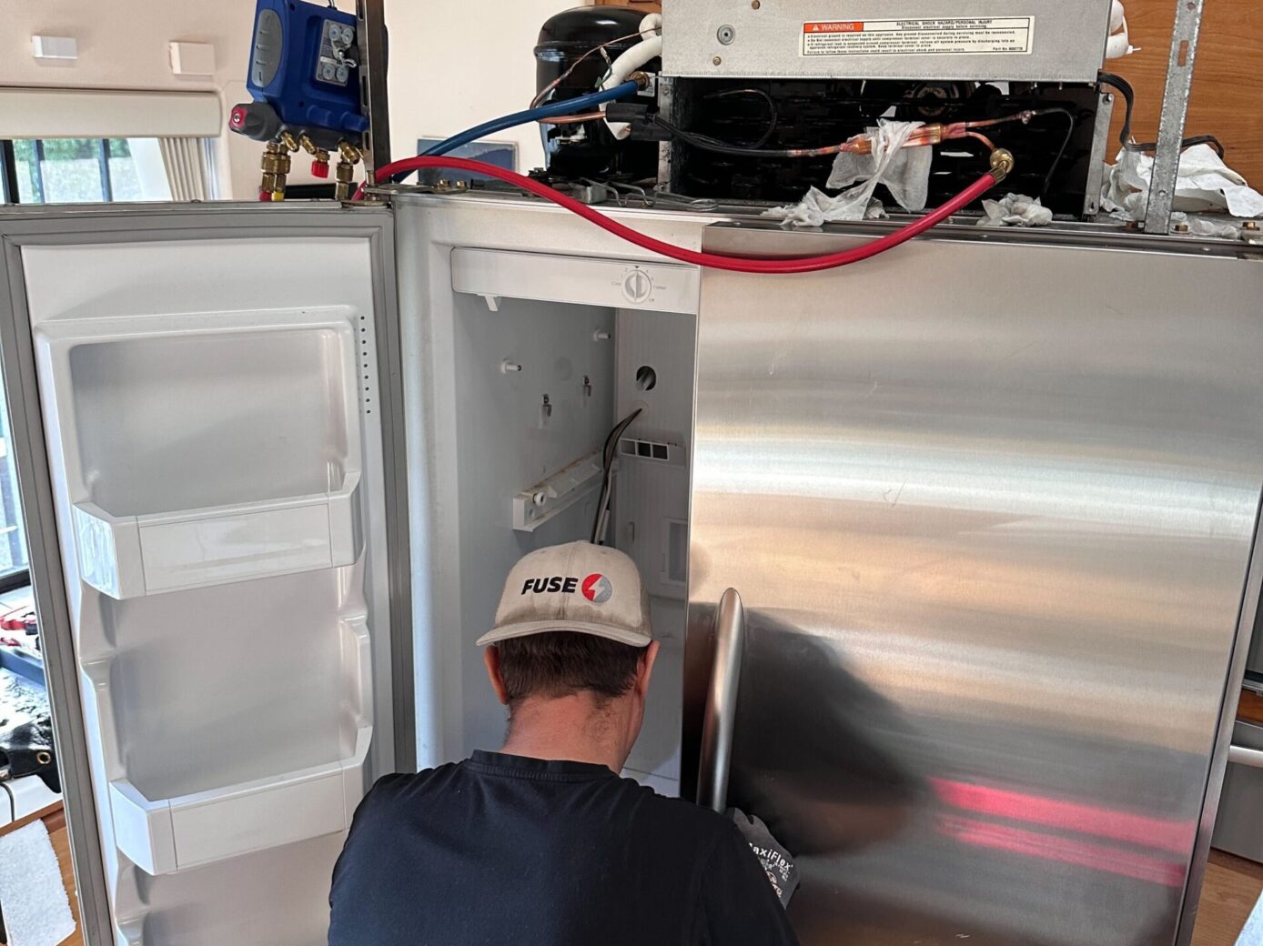 Technician fixing a fridge appliance repair ellicott city md